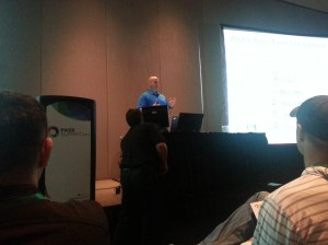 Colin presenting like a boss while tech guy works out issues.